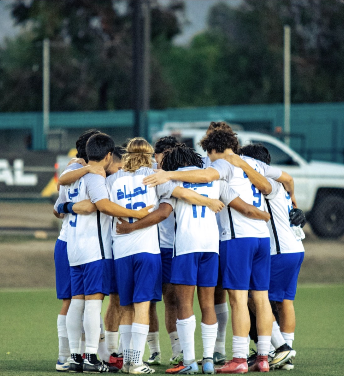 Independent FC team huddle on the pitch